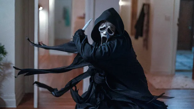 A still from the film Scream of Ghostface killing a victim with a knife